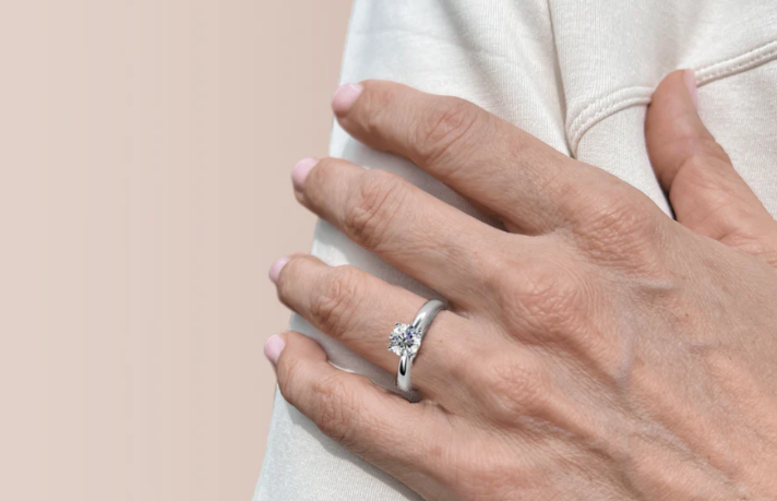 A person wearing a Moissanite ring